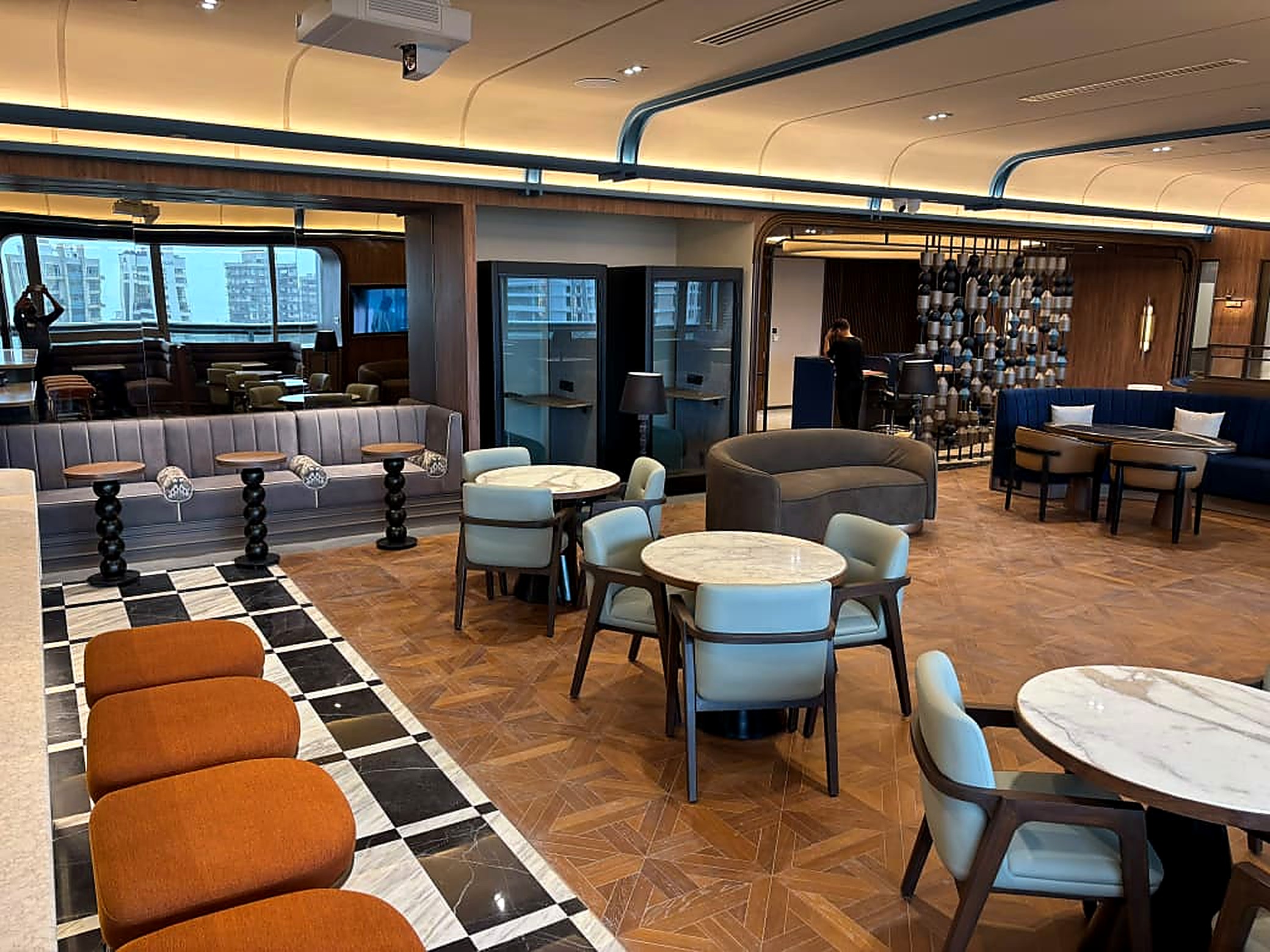 A completed Sparkal Decor workspace &mdash; lounge seating, acoustic pods and caf&eacute; tables in a corporate office